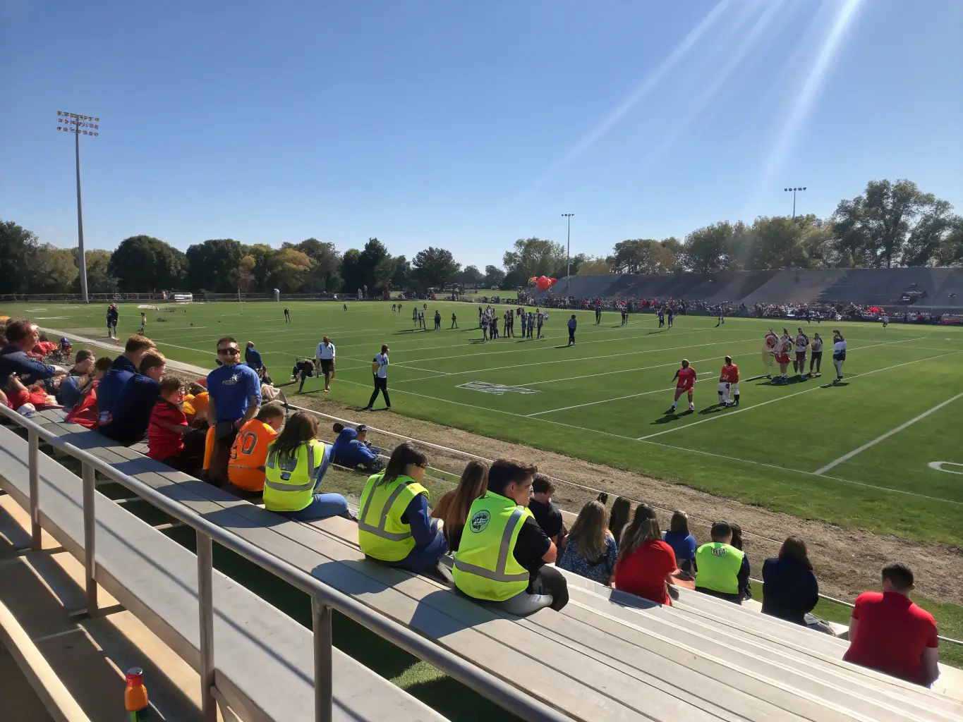 An action shot of a local football team competing in a match, capturing the intensity and excitement of the game, with spectators cheering from the sidelines.